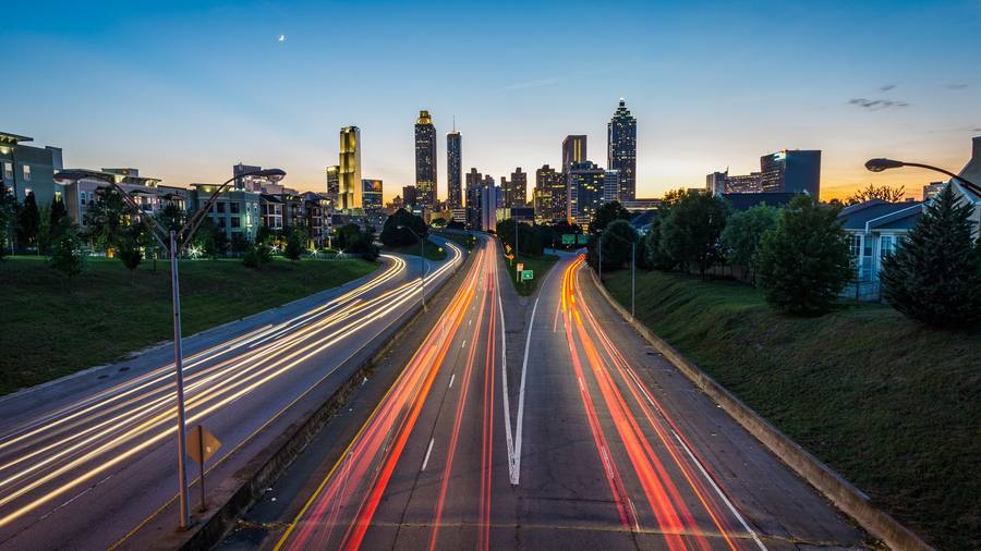 The Atlanta skyline at dusk with highway light trails
