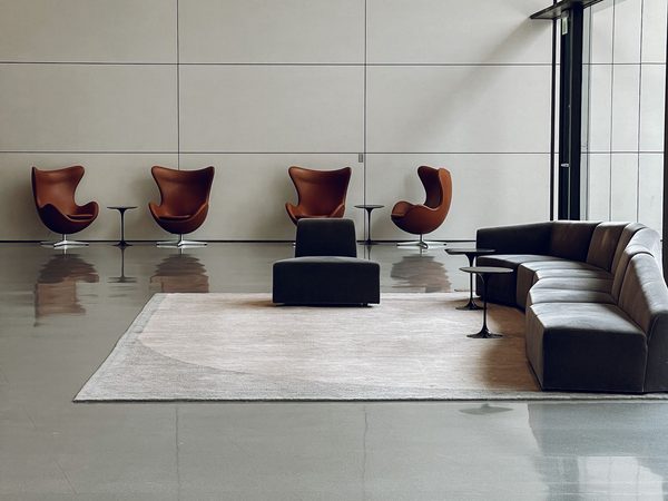 A modern commercial lobby with seating and a polished floor