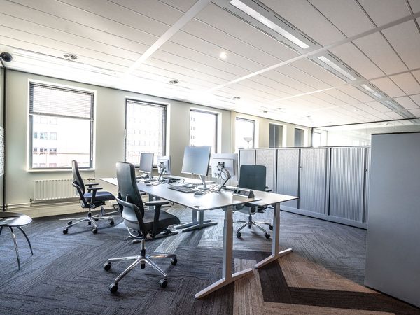 A bright modern office with workstations and large windows